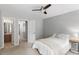 Bright bedroom with a view to the ensuite bathroom, a ceiling fan, and closet at 11210 Lofty Heights Pl, Raleigh, NC 27614