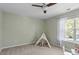 Charming bedroom with gray walls, cozy tent, window view, and light carpeting at 11210 Lofty Heights Pl, Raleigh, NC 27614