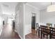 Bright dining area featuring hardwood floors, chair rail detail, and an elegant dining set at 11210 Lofty Heights Pl, Raleigh, NC 27614