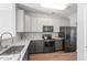 Updated kitchen featuring sleek appliances, granite countertops, and ample cabinet space at 11210 Lofty Heights Pl, Raleigh, NC 27614