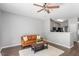 Open-concept living room with hardwood floors, a modern ceiling fan, and a comfortable sofa at 11210 Lofty Heights Pl, Raleigh, NC 27614