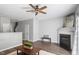 Inviting living area with a fireplace, hardwood floors, and an open layout into the kitchen at 11210 Lofty Heights Pl, Raleigh, NC 27614