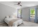 Comfortable main bedroom with natural light, a ceiling fan, and a well-sized closet at 11210 Lofty Heights Pl, Raleigh, NC 27614