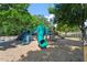 Community playground with slides and climbing structures, surrounded by lush trees and a mulch ground at 11210 Lofty Heights Pl, Raleigh, NC 27614