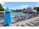 Pool area with lounge chairs, umbrellas, and a view of the clubhouse, creating a relaxing atmosphere at 11210 Lofty Heights Pl, Raleigh, NC 27614