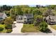 Aerial view of a two-story home with a three-car garage, mature trees, and green lawn at 1140 Buttercup Ln, Wake Forest, NC 27587