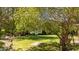 Lush backyard featuring green grass and mature shade trees at 1140 Buttercup Ln, Wake Forest, NC 27587