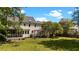 This home has a large backyard with a screened-in porch, a pergola-covered patio, and mature trees, offering privacy and shade at 1140 Buttercup Ln, Wake Forest, NC 27587