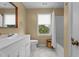 Neutral bathroom with white vanity, toilet, shower/tub, a large mirror and tile floors at 1140 Buttercup Ln, Wake Forest, NC 27587