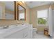 Bright bathroom featuring dual sinks, a large mirror, a walk-in shower and a window offering natural light at 1140 Buttercup Ln, Wake Forest, NC 27587