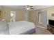 Bedroom has neutral walls, a queen bed, several doorways, and a ceiling fan at 1140 Buttercup Ln, Wake Forest, NC 27587
