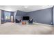 Large bonus room with comfortable seating and natural light, perfect for relaxation and entertainment at 1140 Buttercup Ln, Wake Forest, NC 27587