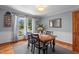 Cozy dining room with hardwood floors, a window, and a wooden table with black chairs on a gray rug at 1140 Buttercup Ln, Wake Forest, NC 27587