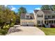 Charming yellow home with a two-car garage, green shutters, and lush landscaping, offering curb appeal at 1140 Buttercup Ln, Wake Forest, NC 27587