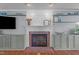 Living room fireplace with brick hearth, white mantel, and built-in shelving at 1140 Buttercup Ln, Wake Forest, NC 27587