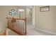 Hallway with wood railing, wall decor, and neutral walls that leads to several rooms at 1140 Buttercup Ln, Wake Forest, NC 27587