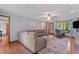 Spacious living room with hardwood floors, large sectional, and natural light at 1140 Buttercup Ln, Wake Forest, NC 27587