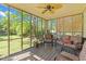 Relaxing screened porch with comfortable seating and a ceiling fan, offering a tranquil space to enjoy the outdoors at 1140 Buttercup Ln, Wake Forest, NC 27587