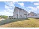 Wide angle view of the back exterior of a gray vinyl sided two story home with a sloped yard at 12 Douglas Fir Pl, Clayton, NC 27520