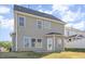 Backyard view of two story home showing vinyl siding, door to the patio, and multiple windows at 12 Douglas Fir Pl, Clayton, NC 27520