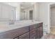Bathroom featuring a double sink vanity with dark wood cabinets and modern fixtures at 12 Douglas Fir Pl, Clayton, NC 27520