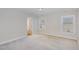 Spacious bedroom with neutral carpet, light walls and ample natural light from two windows at 12 Douglas Fir Pl, Clayton, NC 27520