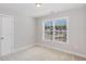 Bedroom featuring neutral walls, a single door closet, and a bright window at 12 Douglas Fir Pl, Clayton, NC 27520