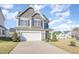 Inviting two-story home with a spacious driveway and well-manicured lawn at 12 Douglas Fir Pl, Clayton, NC 27520