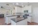 Contemporary kitchen with white cabinets, granite countertops, and stainless steel appliances at 12 Douglas Fir Pl, Clayton, NC 27520