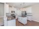 Modern kitchen featuring white cabinets, granite countertops, and stainless steel appliances at 12 Douglas Fir Pl, Clayton, NC 27520