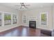 Cozy living room with a fireplace, hardwood floors, and ample natural light at 12 Douglas Fir Pl, Clayton, NC 27520
