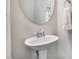 Elegant half-bathroom with a pedestal sink and decorative mirror at 12 Douglas Fir Pl, Clayton, NC 27520