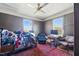 Bedroom with two windows, ceiling fan, rug, and computer desk at 1207 Wall St, Durham, NC 27701