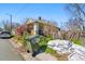 House exterior surrounded by landscaping materials, debris, and trash cans at 1207 Wall St, Durham, NC 27701