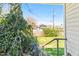 View of a house with solar panels from a porch with overgrown greenery at 1207 Wall St, Durham, NC 27701