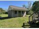 Exterior view of block outbuilding with secure door; great for storage and projects at 125 S State St, Haw River, NC 27258