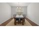 Formal dining room with a large table, chairs, chandelier, and a window with blinds at 126 Elmsford St, Durham, NC 27703