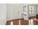 Bright entryway featuring hardwood floors, a white front door with sidelights, and a console table at 126 Elmsford St, Durham, NC 27703