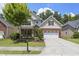 Well-maintained two-story home with a brick and stone facade, lush lawn, and attached two-car garage at 126 Elmsford St, Durham, NC 27703