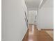 Bright hallway with hardwood floors leading to the front door and other rooms at 126 Elmsford St, Durham, NC 27703