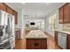 Open kitchen featuring a large island with a granite countertop and stainless steel appliances at 126 Elmsford St, Durham, NC 27703
