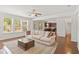 Bright living room featuring hardwood floors, a ceiling fan, and lots of natural light at 126 Elmsford St, Durham, NC 27703