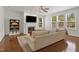 Cozy living room with hardwood floors, a fireplace, a mounted TV, and a comfortable sofa at 126 Elmsford St, Durham, NC 27703