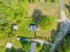 A beautiful aerial view of the property showing the house, trees, green grass, and surrounding land at 12601 Boyce Mill Rd, Raleigh, NC 27613