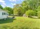 Expansive backyard with a storage building, a well-maintained lawn, and mature trees at 12601 Boyce Mill Rd, Raleigh, NC 27613