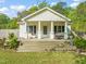 Charming home featuring a spacious front porch with swing, perfect for enjoying the outdoors at 12601 Boyce Mill Rd, Raleigh, NC 27613