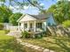 Inviting home with a cozy front porch, lush greenery, and a stone pathway at 12601 Boyce Mill Rd, Raleigh, NC 27613