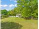 Inviting home with a well-manicured lawn, mature trees, and charming front porch at 12601 Boyce Mill Rd, Raleigh, NC 27613
