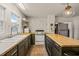 Well-lit kitchen with butcher block countertops, an island and a stainless fridge at 12601 Boyce Mill Rd, Raleigh, NC 27613