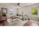 Sunlit living room showcasing a comfortable sofa, accent chair, and a view to the outdoors at 12601 Boyce Mill Rd, Raleigh, NC 27613